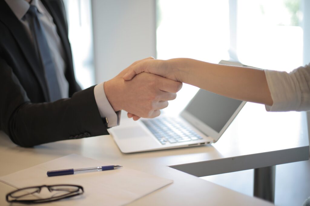 employees shaking hands | Infinity Group